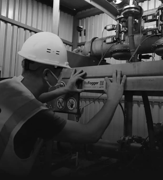 Technician inspecting a ReFogger unit at a panel plant